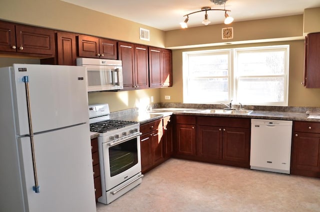 4819 Conrad St, Skokie, IL 60077 - kitchen featuring visible vents, dark countertops, a sink, light floors, and white appliances
