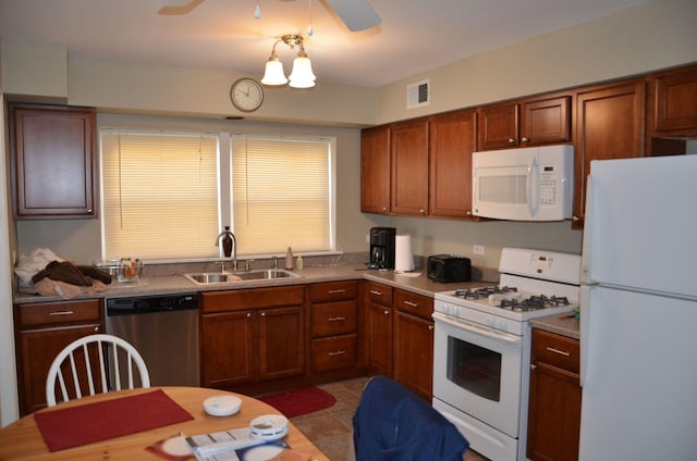 4819 Conrad St, Skokie, IL 60077 - kitchen featuring a sink, brown cabinetry, white appliances, and visible vents