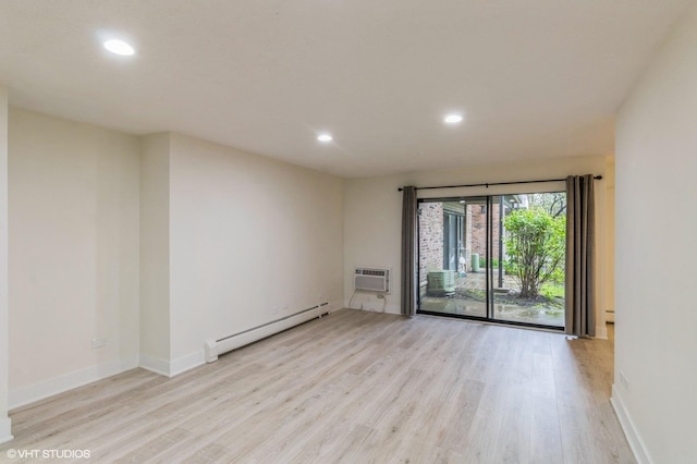 empty room featuring light wood-style floors, recessed lighting, baseboards, a baseboard radiator, and a wall mounted AC