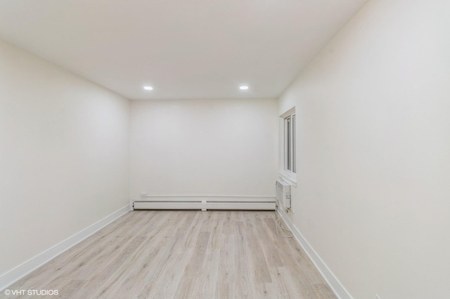 unfurnished room featuring recessed lighting, baseboards, a baseboard heating unit, and wood finished floors