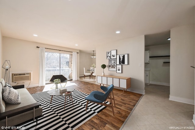 living area featuring baseboards, tile patterned floors, an AC wall unit, and recessed lighting