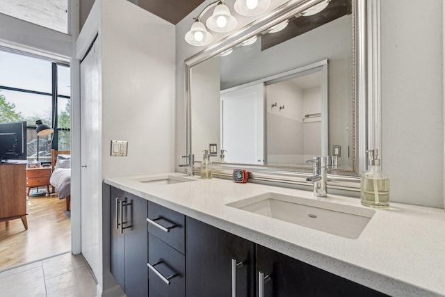 ensuite bathroom featuring connected bathroom, double vanity, and a sink