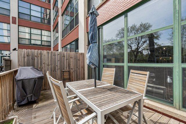 deck featuring outdoor dining space and area for grilling