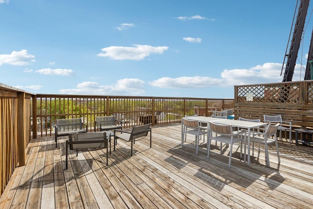 wooden deck featuring outdoor dining area