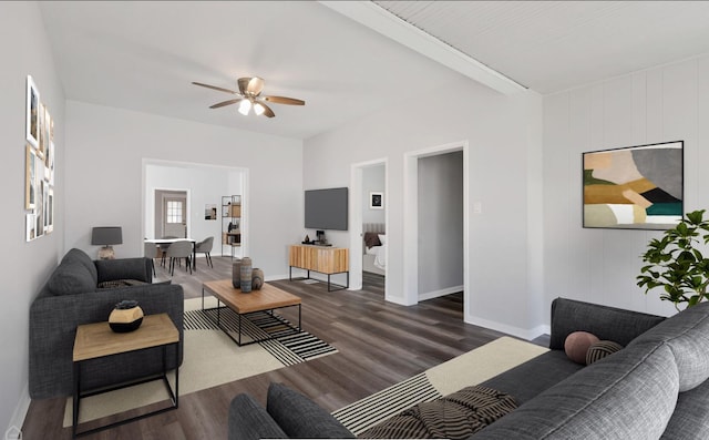 living room featuring a ceiling fan, baseboards, and wood finished floors