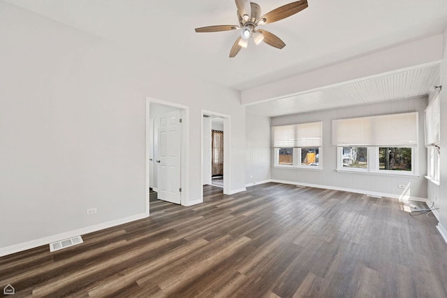 spare room featuring a ceiling fan, baseboards, visible vents, and dark wood-type flooring