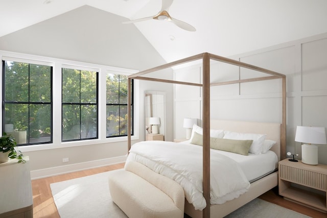 bedroom with lofted ceiling, wood finished floors, ceiling fan, and baseboards