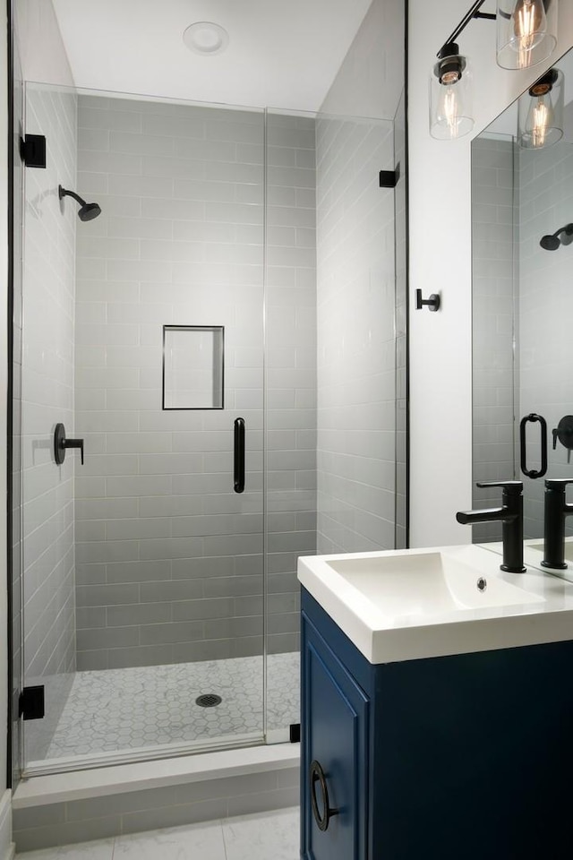 full bathroom with a stall shower and vanity