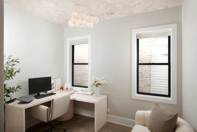 carpeted home office featuring visible vents, baseboards, and plenty of natural light