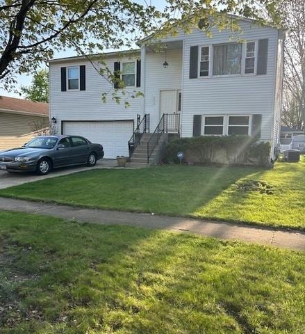 split foyer home with an attached garage, a front lawn, and concrete driveway