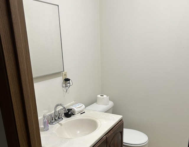 half bathroom featuring toilet and vanity
