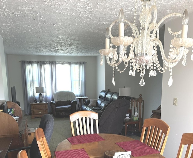 dining room featuring carpet flooring, a textured ceiling, and a notable chandelier