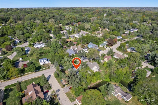 birds eye view of property with a view of trees