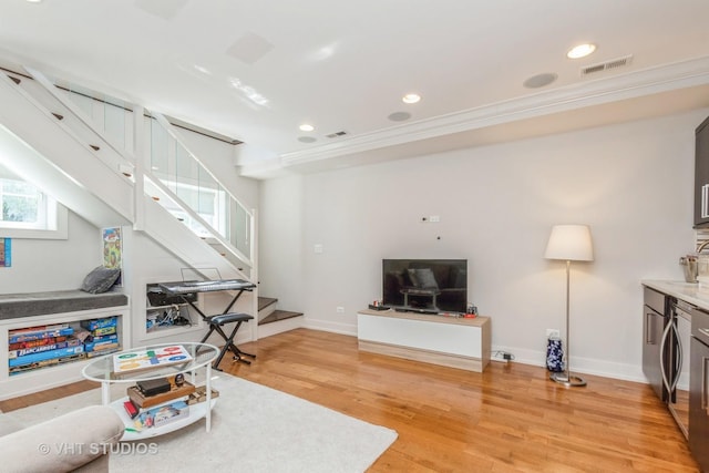 1754 W Wellington Ave Unit 1W, Chicago, IL 60657 - living room featuring stairway, light wood-style flooring, recessed lighting, baseboards, and crown molding