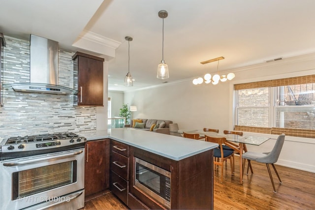 1754 W Wellington Ave Unit 1W, Chicago, IL 60657 - kitchen with stainless steel appliances, wall chimney range hood, ornamental molding, dark brown cabinetry, and tasteful backsplash