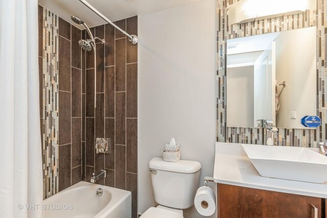 1754 W Wellington Ave Unit 1W, Chicago, IL 60657 - bathroom featuring toilet, vanity, shower / bathtub combination, and decorative backsplash