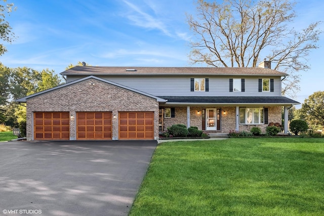 28139 W Okelly Dr, Ingleside, IL 60041 - traditional-style house with a front lawn, a garage, a chimney, covered porch, and driveway