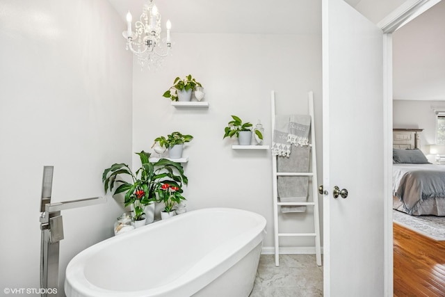 28139 W Okelly Dr, Ingleside, IL 60041 - ensuite bathroom featuring an inviting chandelier, a freestanding tub, ensuite bathroom, and baseboards