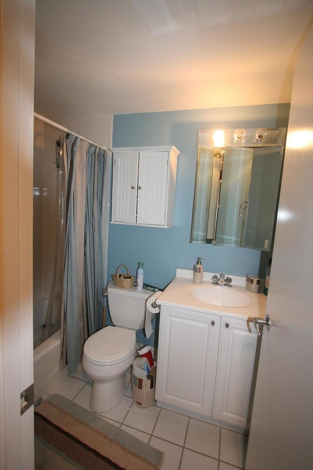bathroom featuring toilet, tile patterned flooring, vanity, and shower / bathtub combination with curtain