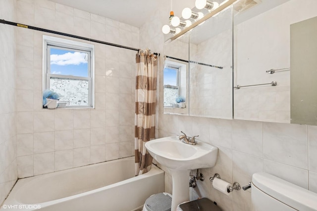 bathroom featuring toilet, tile walls, backsplash, and shower / tub combo with curtain