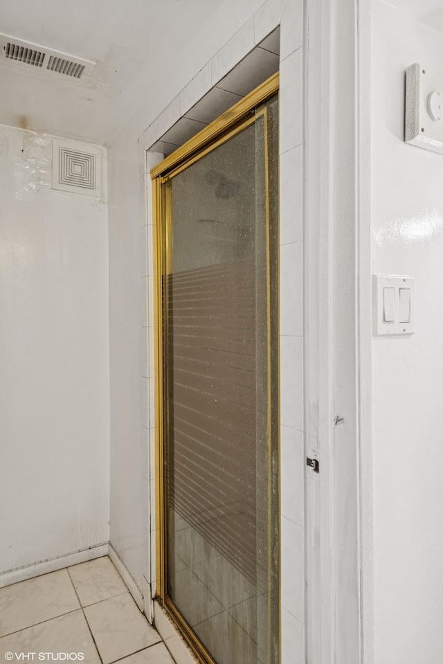 full bathroom featuring visible vents, a shower stall, and tile patterned flooring