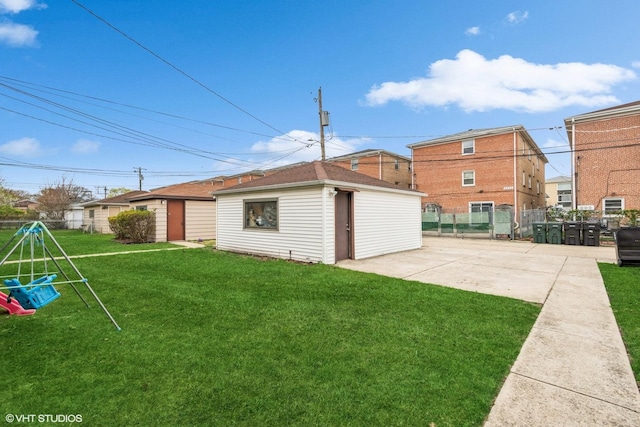 exterior space with fence, an outdoor structure, and a patio area