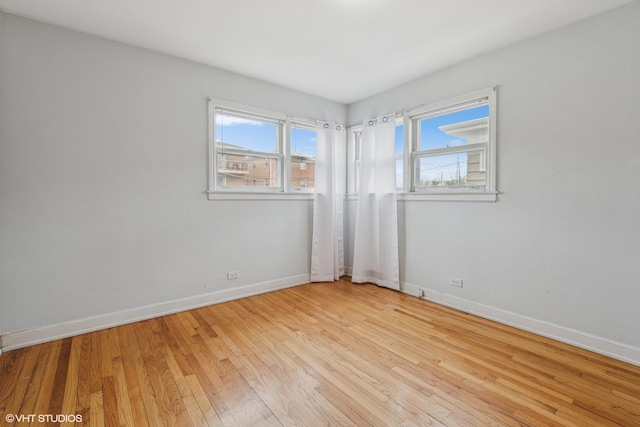 empty room featuring light wood-style flooring and baseboards