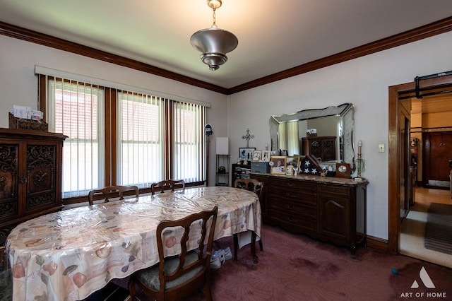 dining area with a barn door, ornamental molding, and carpet