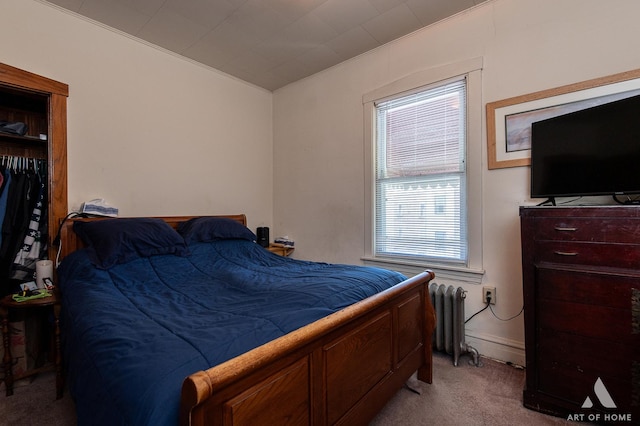 bedroom featuring radiator heating unit and carpet floors