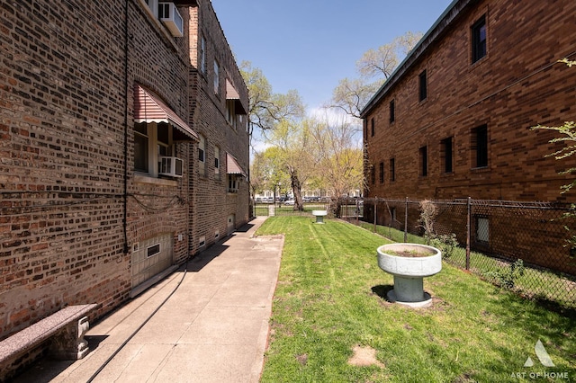 view of property's community with fence and a yard