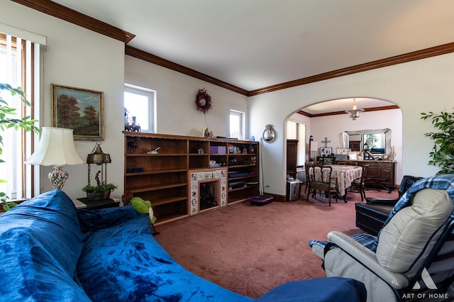 carpeted living room featuring crown molding and arched walkways