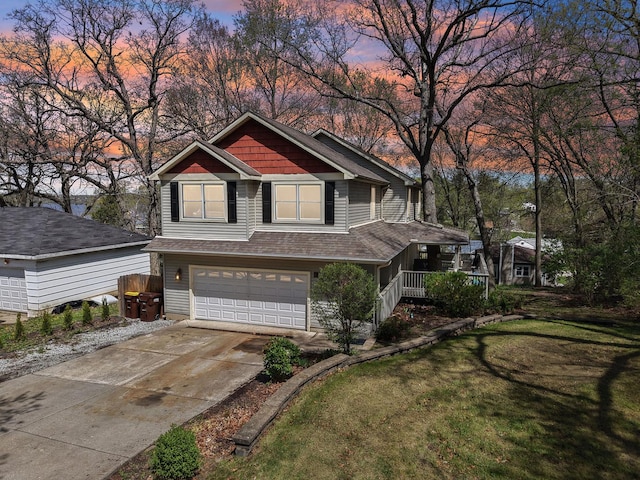craftsman house featuring driveway, an attached garage, a front yard, covered porch, and roof with shingles