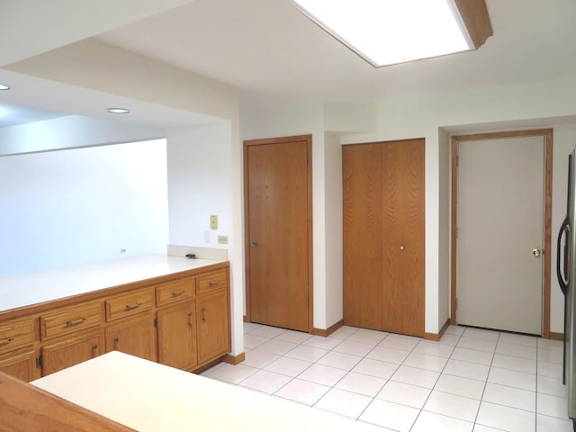 1321 Dresden Dr Unit C, Morris, IL 60450 - kitchen with light countertops, recessed lighting, freestanding refrigerator, and brown cabinets