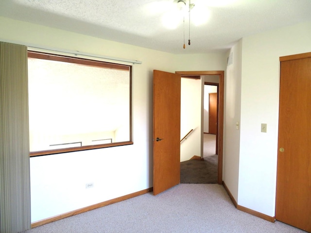 1321 Dresden Dr Unit C, Morris, IL 60450 - unfurnished bedroom featuring baseboards and light carpet