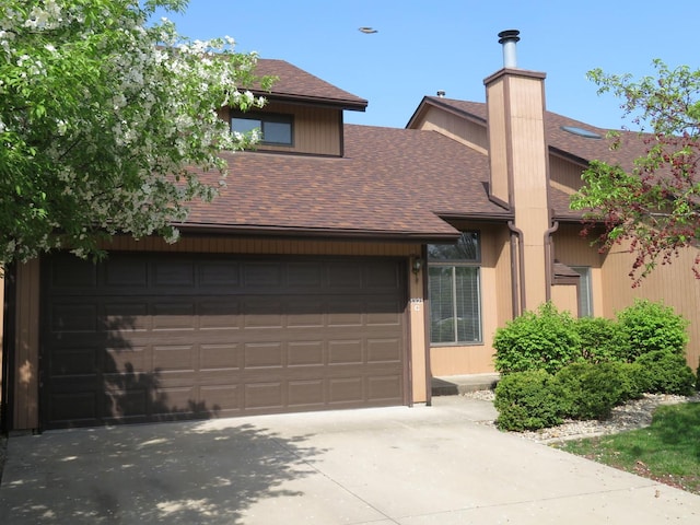 1321 Dresden Dr Unit C, Morris, IL 60450 - view of front of home with a garage, roof with shingles, a chimney, and concrete driveway