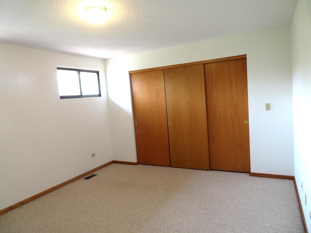 1321 Dresden Dr Unit C, Morris, IL 60450 - unfurnished bedroom featuring baseboards, light colored carpet, visible vents, and a closet