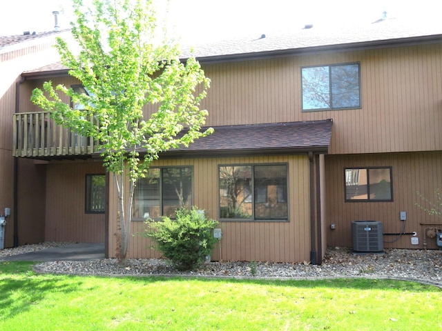1321 Dresden Dr Unit C, Morris, IL 60450 - rear view of property with a lawn, roof with shingles, and central air condition unit