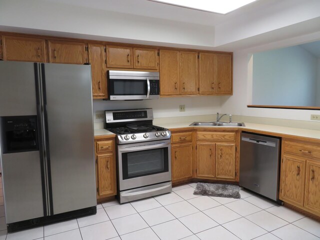 1321 Dresden Dr Unit C, Morris, IL 60450 - kitchen featuring a sink, appliances with stainless steel finishes, brown cabinetry, and light countertops
