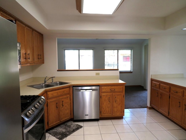 1321 Dresden Dr Unit C, Morris, IL 60450 - kitchen featuring brown cabinetry, a peninsula, a sink, and appliances with stainless steel finishes