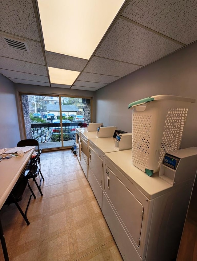 laundry area with washing machine and clothes dryer and light flooring