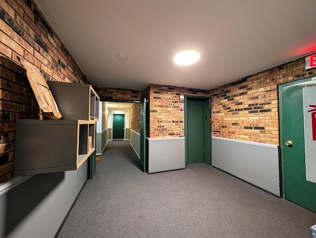 hallway with carpet and brick wall