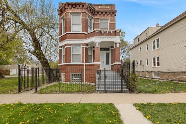 view of front of home featuring a fenced front yard, brick siding, and a gate
