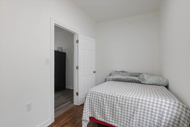 bedroom with wood finished floors and baseboards