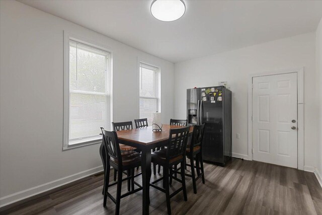 dining area featuring baseboards and dark wood-style floors