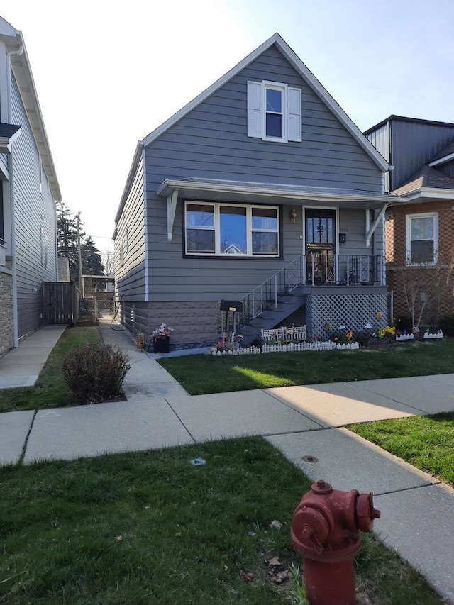 5030 N Keeler Ave, Chicago, IL 60630 - bungalow-style home featuring a porch and a front lawn