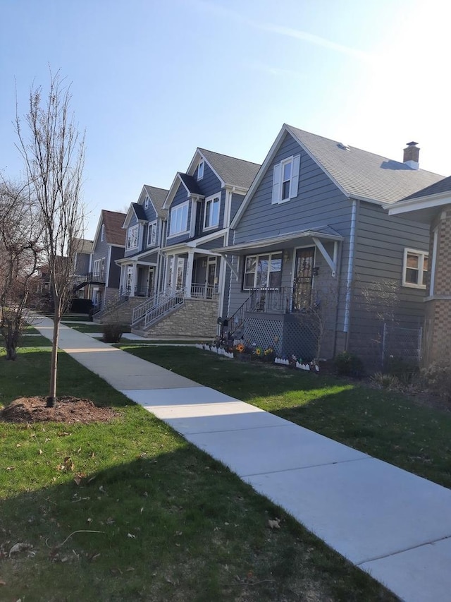 5030 N Keeler Ave, Chicago, IL 60630 - view of front of property featuring a porch, a residential view, a front yard, and a chimney