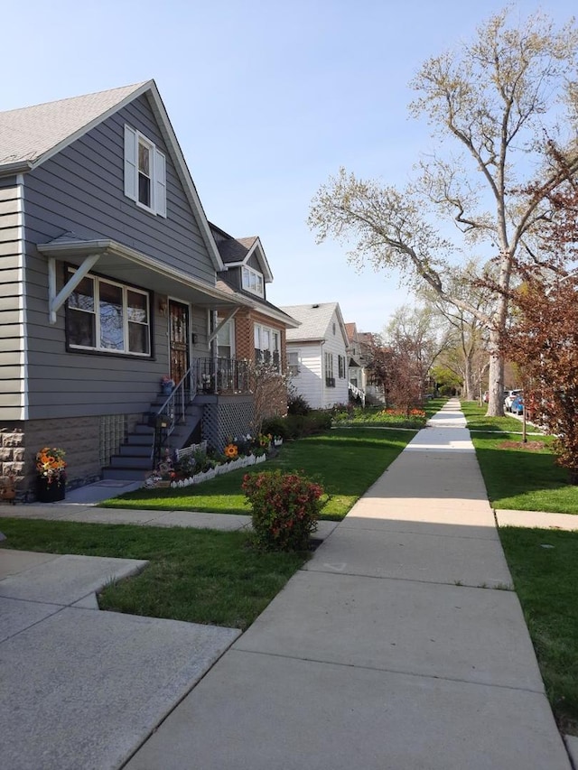 5030 N Keeler Ave, Chicago, IL 60630 - view of front of home featuring covered porch and a front lawn