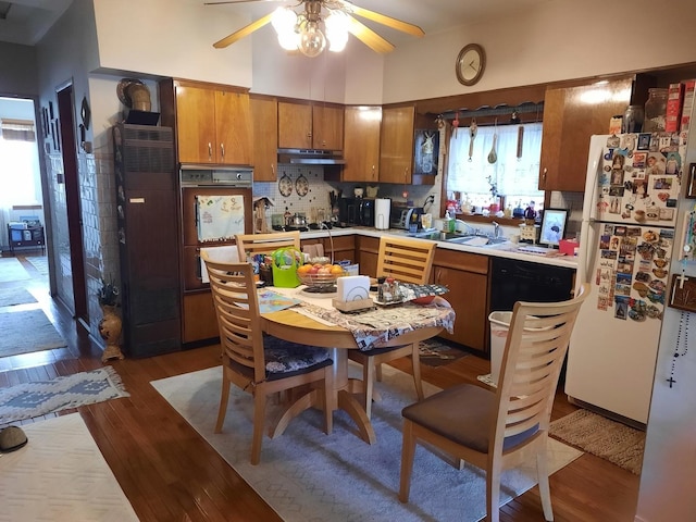 5030 N Keeler Ave, Chicago, IL 60630 - kitchen featuring ceiling fan, white appliances, brown cabinetry, wood finished floors, and under cabinet range hood