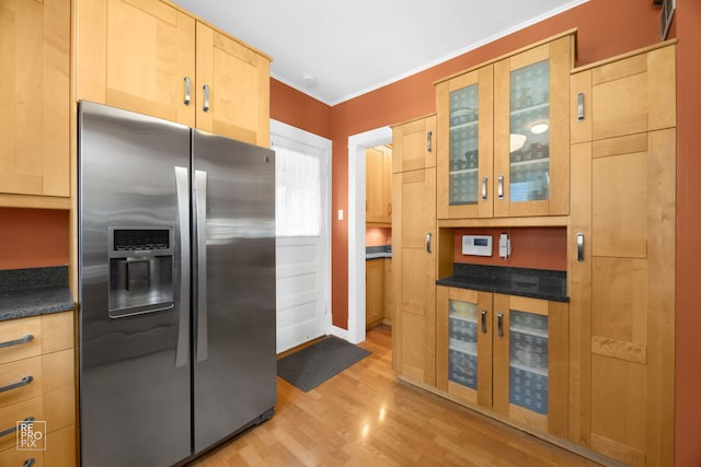 3231 Wesley Ave, Berwyn, IL 60402 - kitchen with glass insert cabinets, light brown cabinetry, light wood-style floors, dark countertops, and stainless steel refrigerator with ice dispenser
