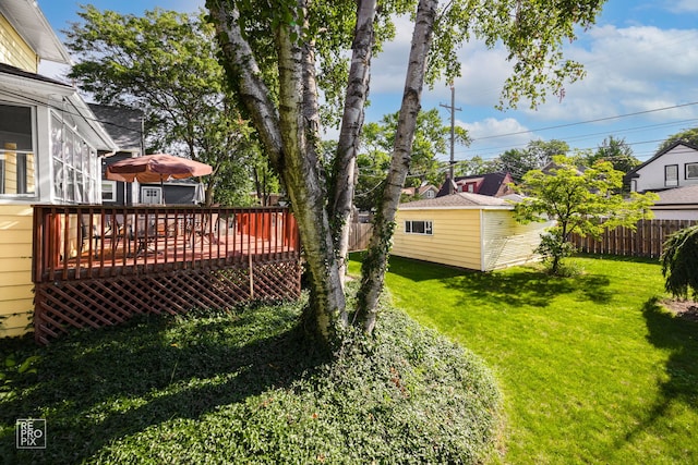 3231 Wesley Ave, Berwyn, IL 60402 - view of yard featuring fence, a wooden deck, and an outbuilding